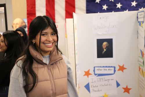 A student poses with a project